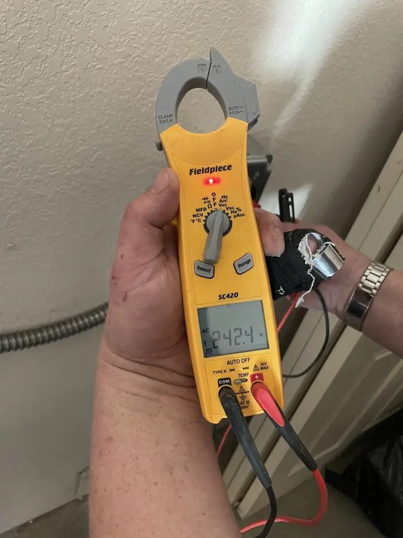 Voltage testing with clamp meter during Ceiling Fan Installation in Interlaken